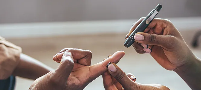 A finger-prick blood sugar check at home