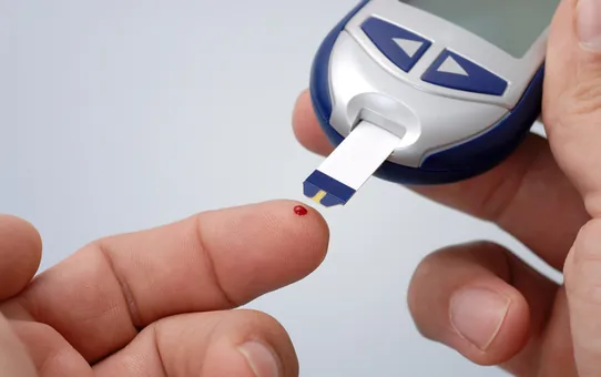 A glucometer testing a drop of blood